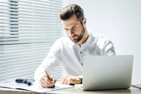 Director at a desk reviewing correspondence and tax paperwork